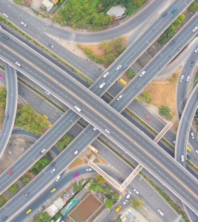 Aerial view of cars driving on highway or moterway. Overpass bridge street roads in connection network of architecture concept. Top view. Urban city, Bangkok, Thailand.